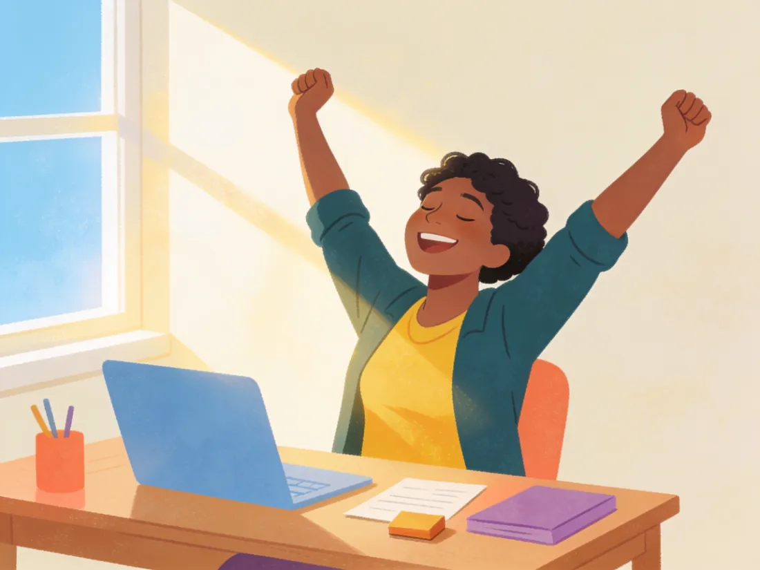 A person stretching happily at a desk after finishing a small task.